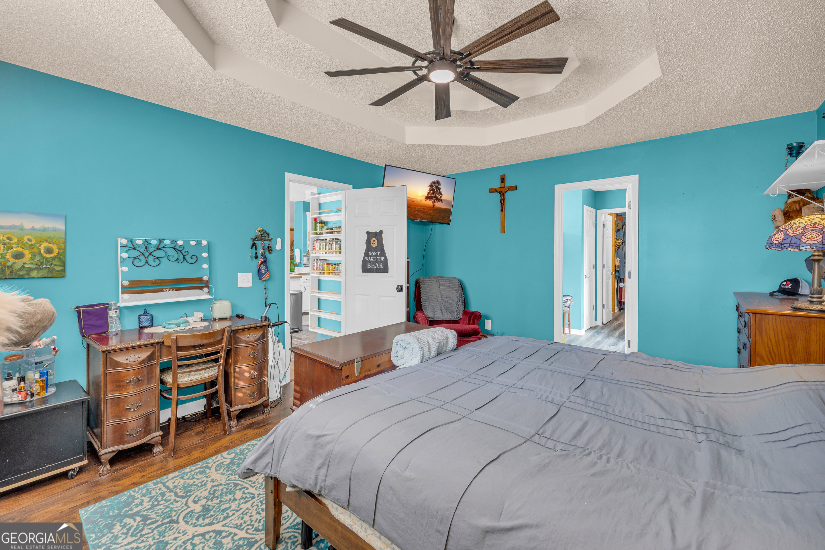 139 Silverstone Circle Jefferson, GA 30549 - Photo 50 of 85 a bedroom with a bed and a chandelier