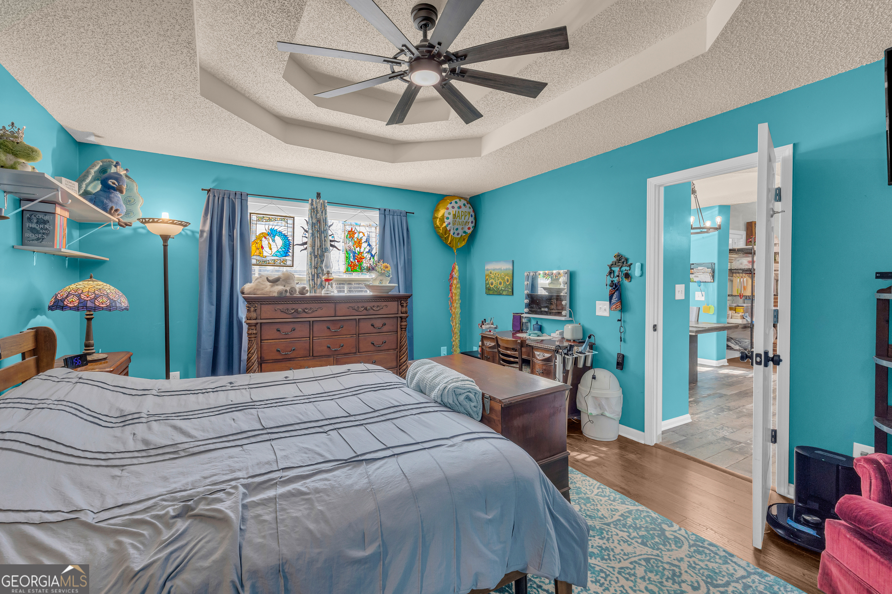 139 Silverstone Circle Jefferson, GA 30549 - Photo 51 of 85 a bedroom with a bed table closet and a flat tv screen