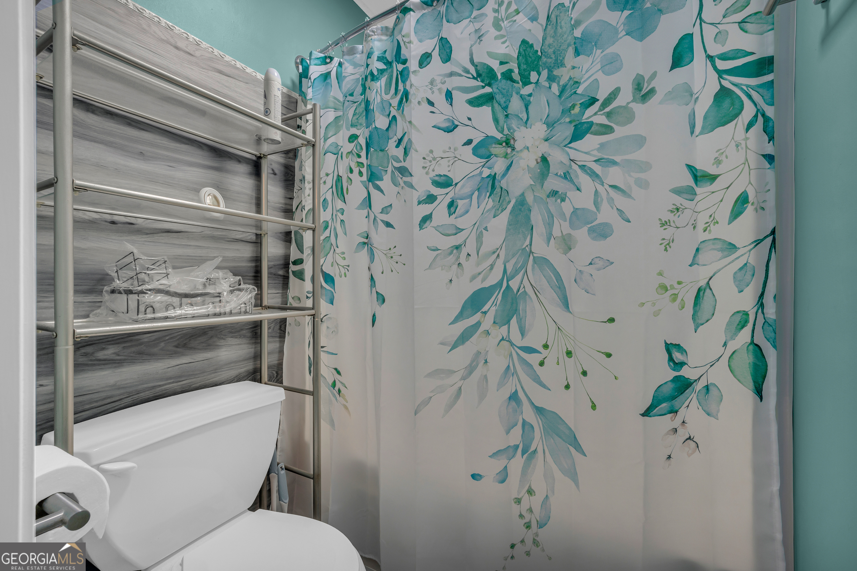 139 Silverstone Circle Jefferson, GA 30549 - Photo 59 of 85 a white toilet sitting next to a shower curtain