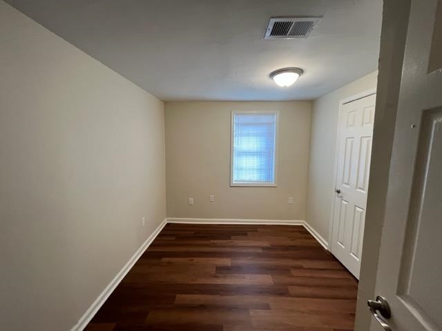 858 Eyers Road Memphis, TN 38109 - Photo 19 of 27 an empty room with wooden floor and windows