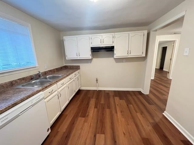 858 Eyers Road Memphis, TN 38109 - Photo 5 of 27 a kitchen with wooden floors and white appliances