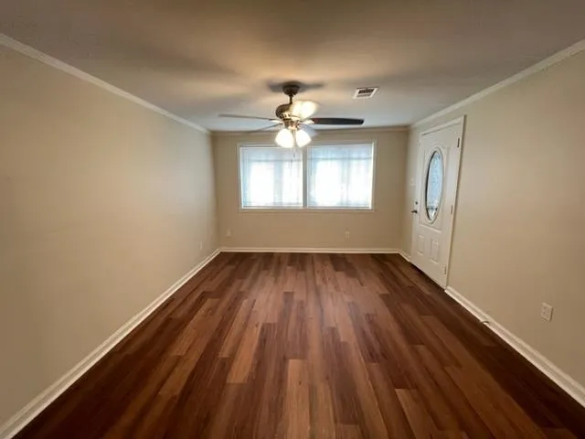 wooden floor in an empty room with a window