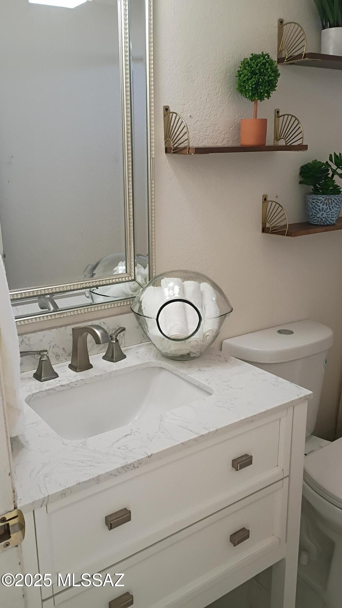 1449 West Hualpai Road Tucson, AZ 85745 - Photo 25 of 49 a bathroom with a sink and a mirror