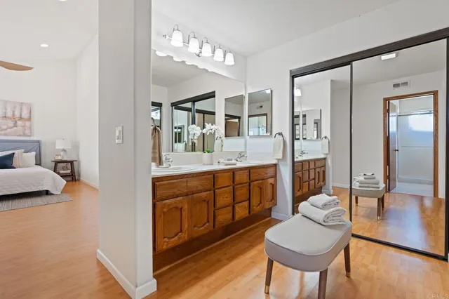 a spacious bathroom with a granite countertop sink and a mirror
