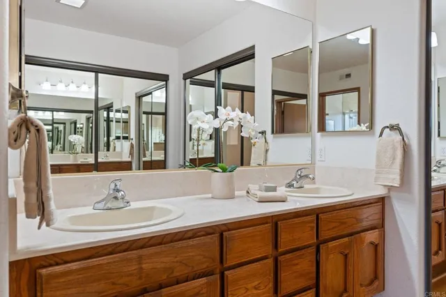 a bathroom with a sink double vanity and a mirror
