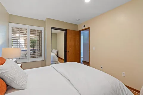 a bedroom with a large bed and a large window