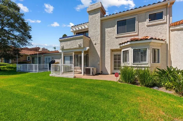 a view of a house with backyard and porch with a yard
