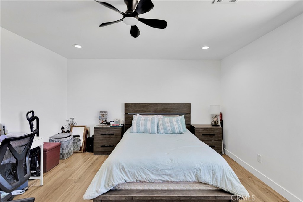 8038 Begonia Road Phelan, CA 92371 - Photo 29 of 49 a bedroom with a bed and a chandelier