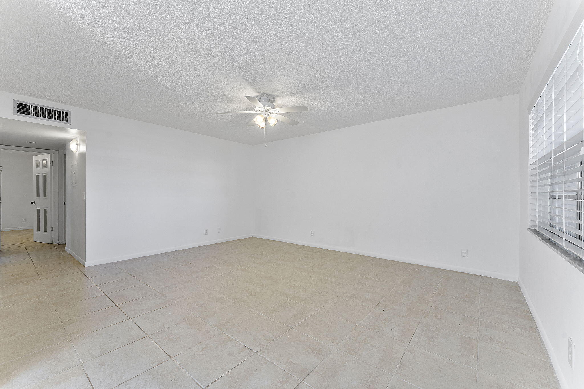 877 Flanders South Delray Beach, FL 33484 - Photo 11 of 27 an empty room with a ceiling fan and a window