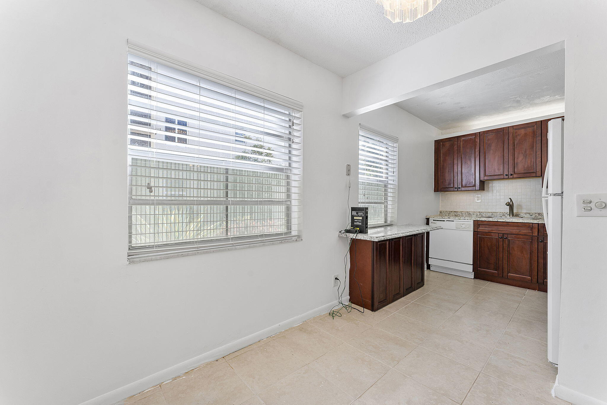 877 Flanders South Delray Beach, FL 33484 - Photo 12 of 27 a kitchen with sink a refrigerator and cabinets