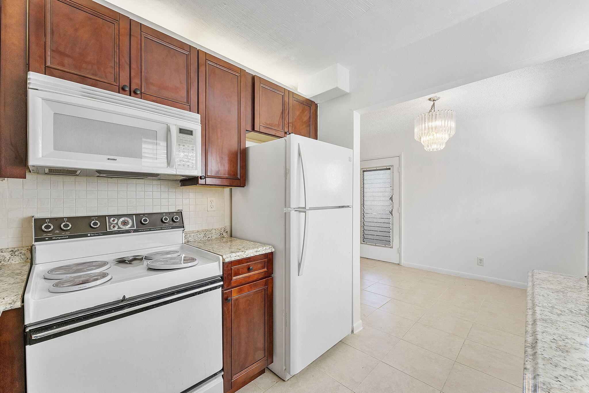 877 Flanders South Delray Beach, FL 33484 - Photo 15 of 27 a kitchen with a refrigerator sink stove and microwave