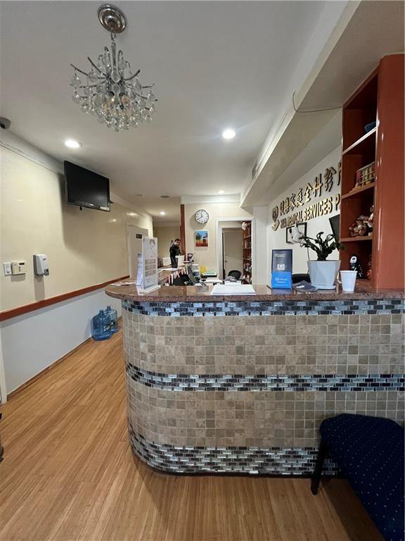 1729 East 16th Street Brooklyn, NY 11229 - Photo 2 of 10 a view of a room with kitchen island stainless steel appliances wooden floor and a counter top space