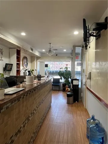 a kitchen with sink refrigerator and view of living room