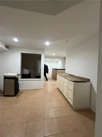 a large room with a couch and a flat screen tv