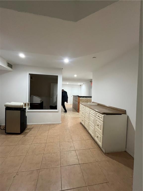 1729 East 16th Street Brooklyn, NY 11229 - Photo 8 of 10 a large room with a couch and a flat screen tv