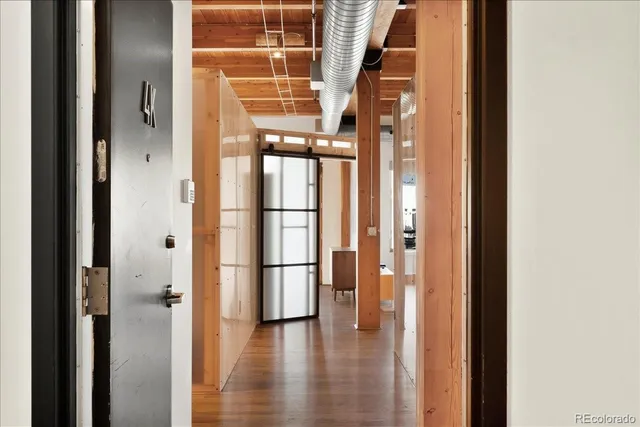 a view of an entryway with wooden floor