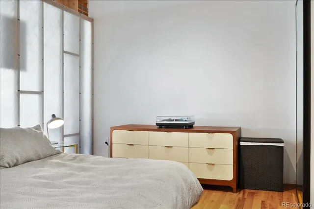 a bedroom with a bed and lamp