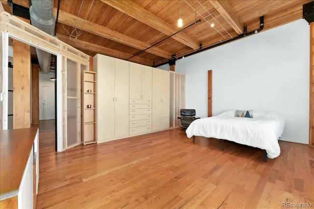 a view of bedroom with furniture and wooden floor