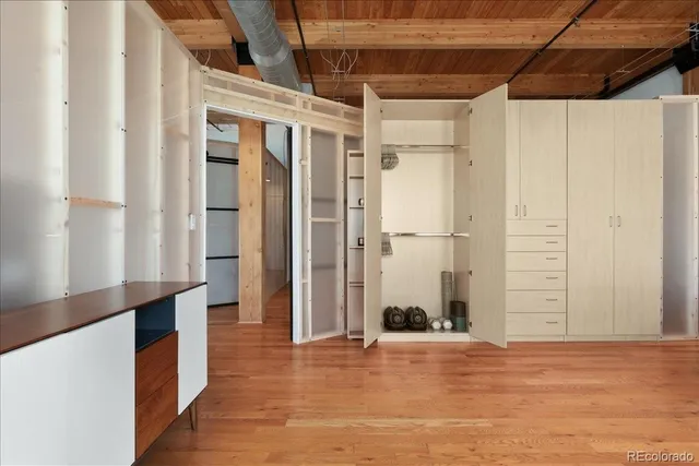 a view of a room with wooden floor and windows