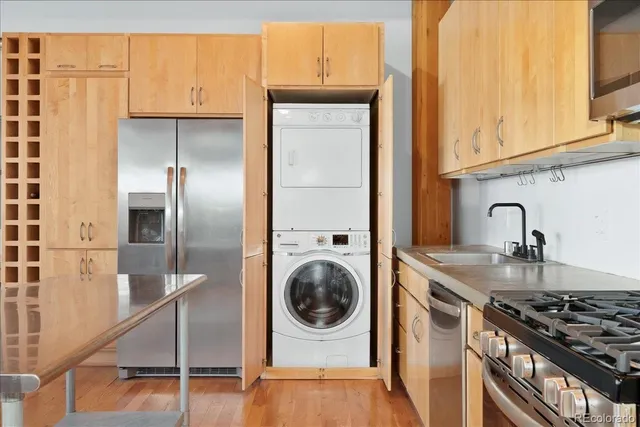 a kitchen with a sink a stove and cabinets
