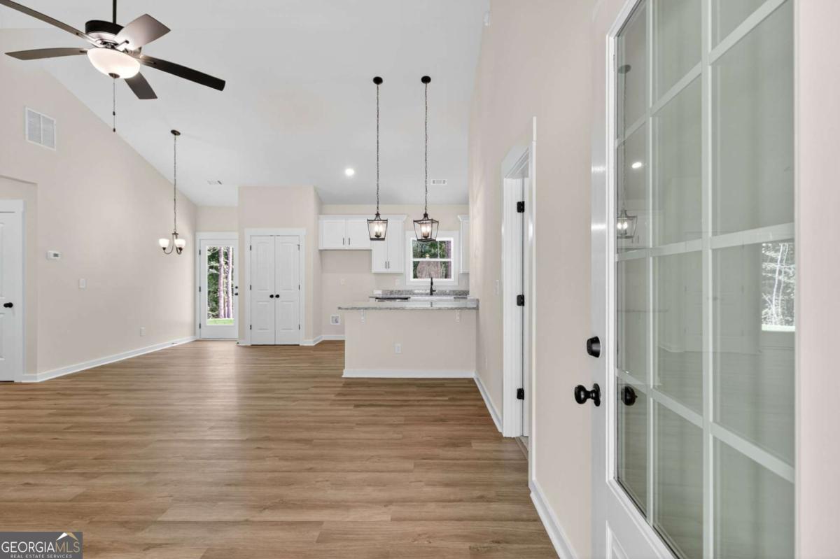 1081 Drummond Road Cedartown, GA 30125 - Photo 11 of 67 a view of a kitchen with wooden floor and a ceiling fan