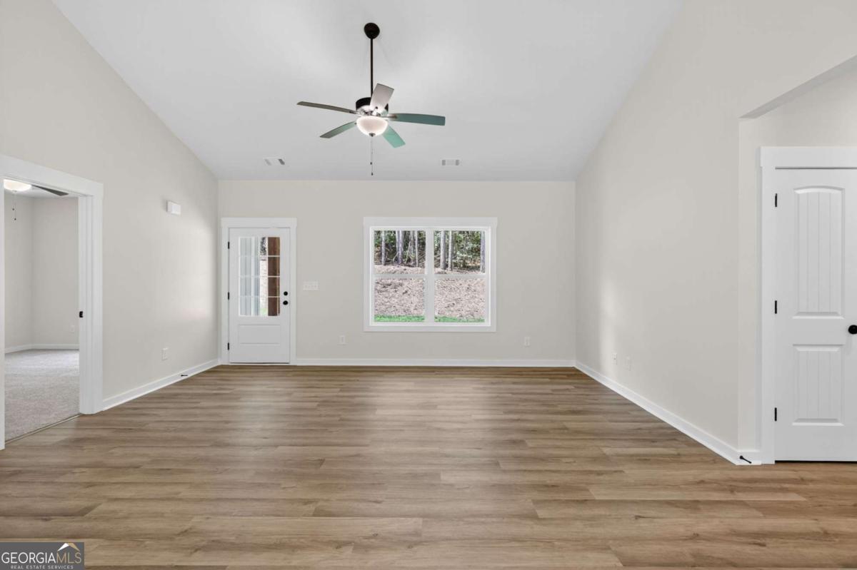 1081 Drummond Road Cedartown, GA 30125 - Photo 17 of 67 a view of an empty room with wooden floor and a window