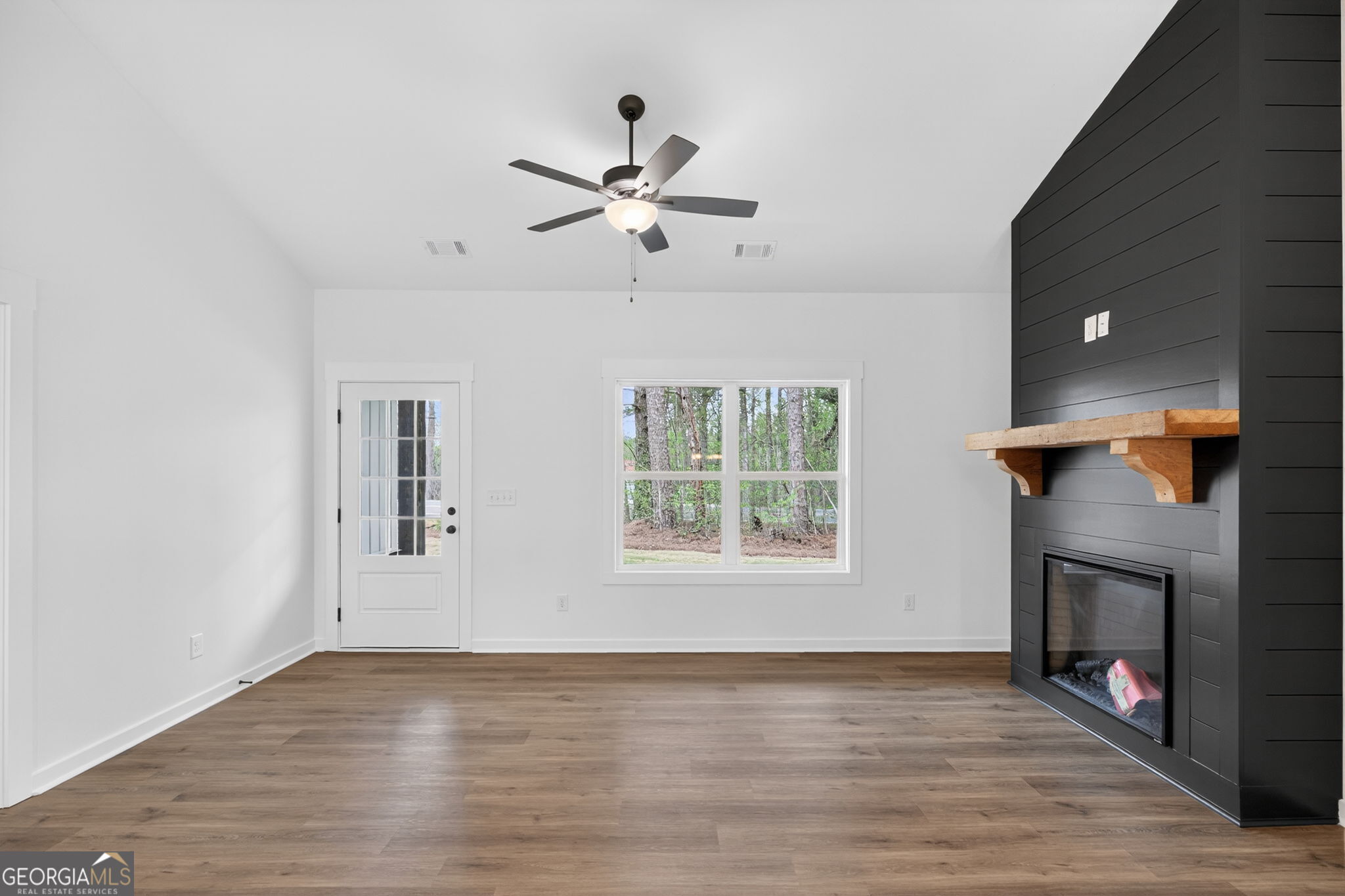 1081 Drummond Road Cedartown, GA 30125 - Photo 24 of 67 an empty room with windows and a fireplace