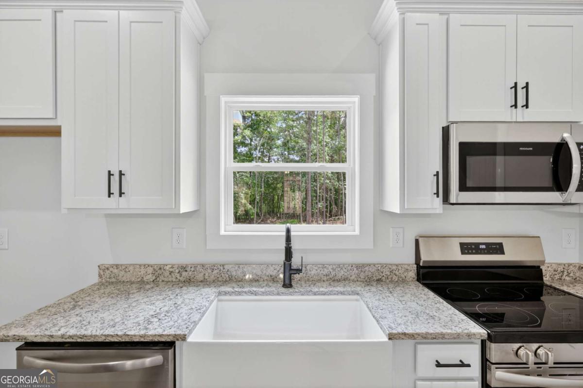 1081 Drummond Road Cedartown, GA 30125 - Photo 25 of 67 a kitchen with stainless steel appliances granite countertop a sink and a microwave