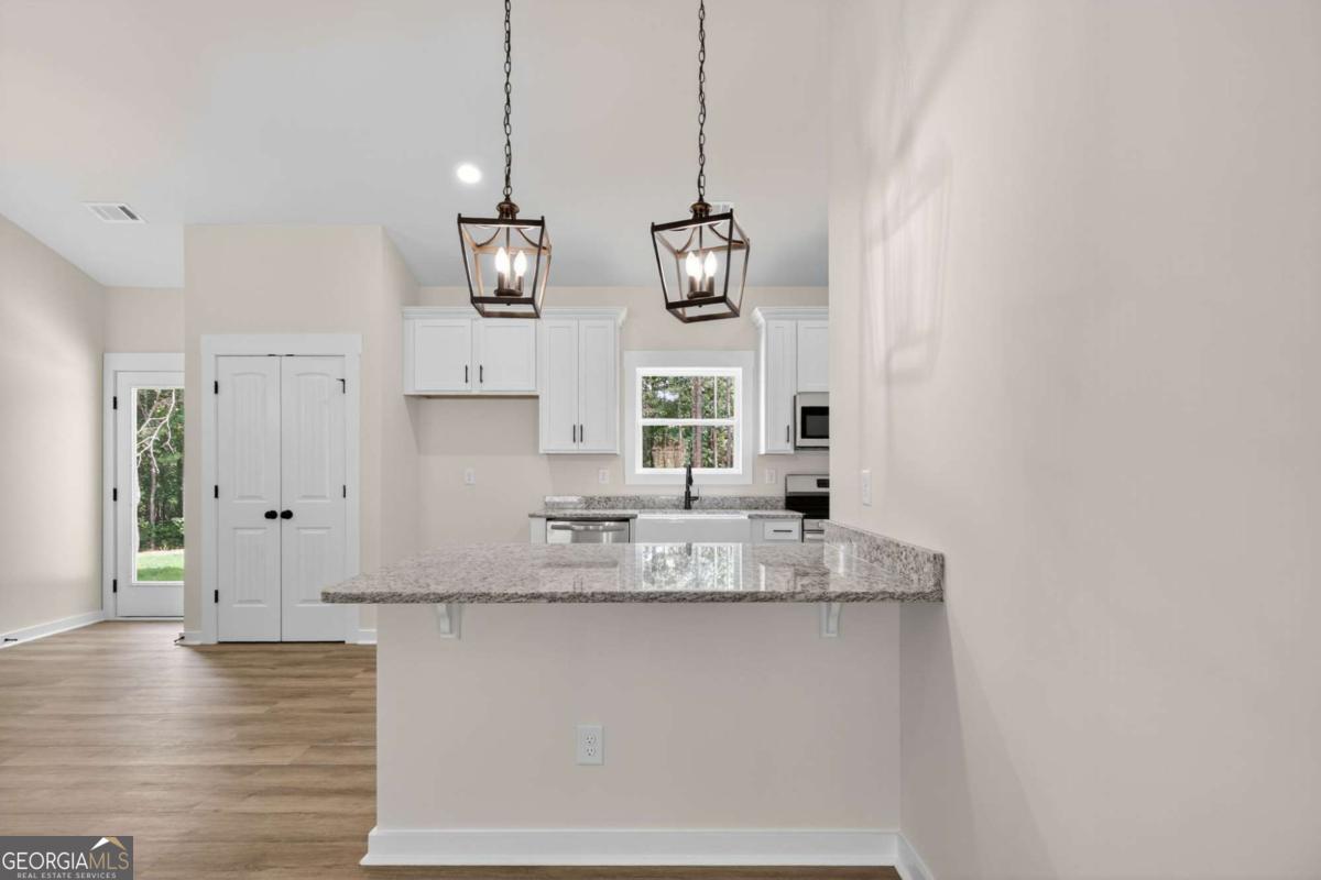 1081 Drummond Road Cedartown, GA 30125 - Photo 27 of 67 a view of a kitchen with granite countertop cabinets and wooden floor