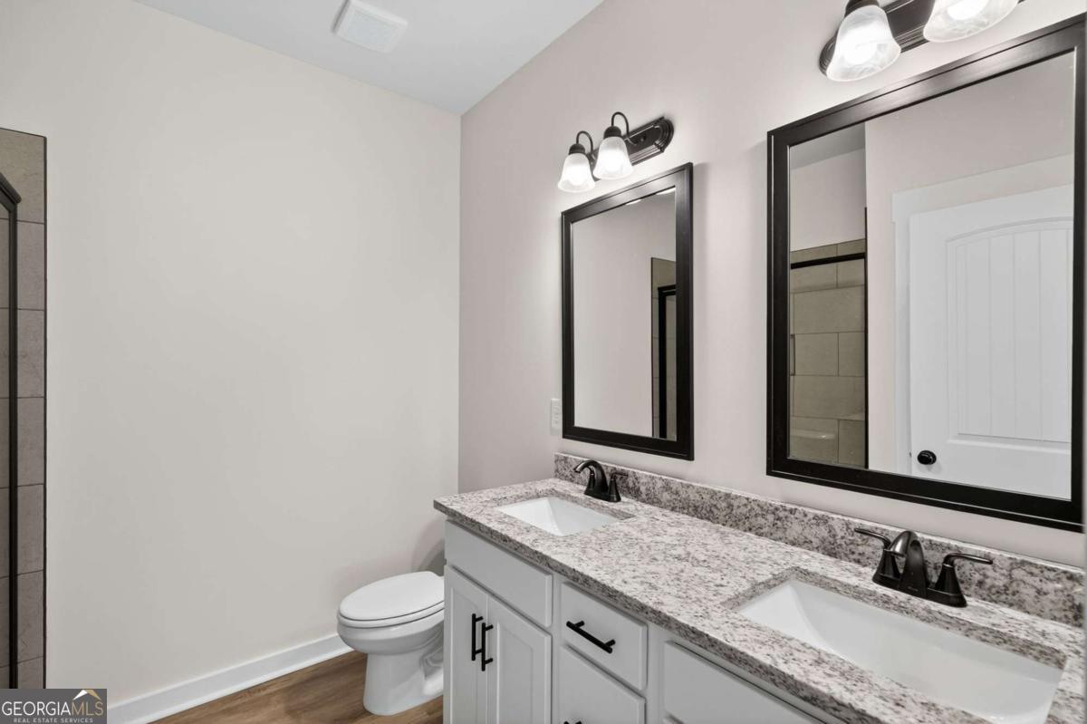 1081 Drummond Road Cedartown, GA 30125 - Photo 39 of 67 a bathroom with a granite countertop sink and a mirror