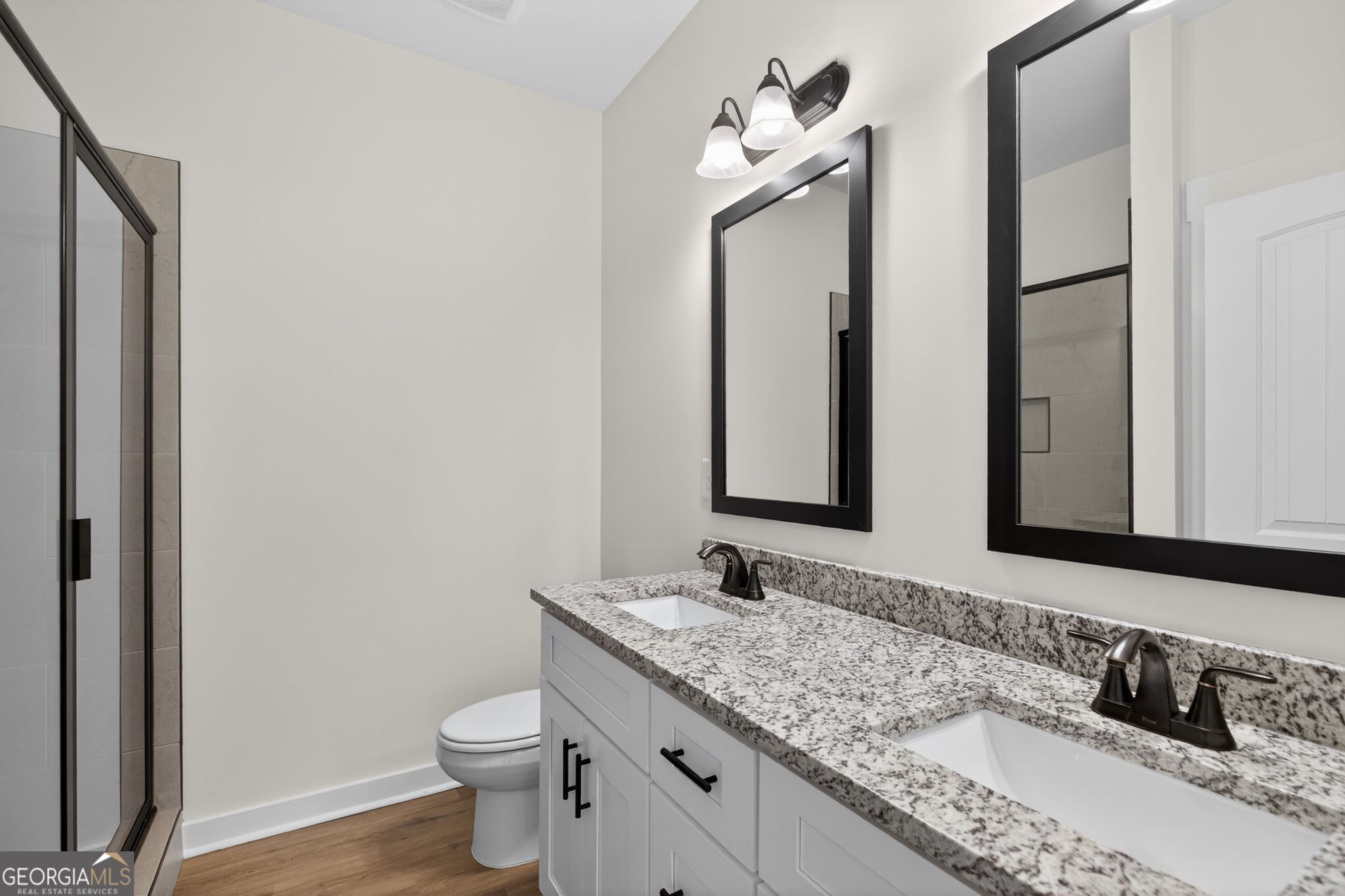 1081 Drummond Road Cedartown, GA 30125 - Photo 46 of 67 a bathroom with a granite countertop sink a toilet and a mirror
