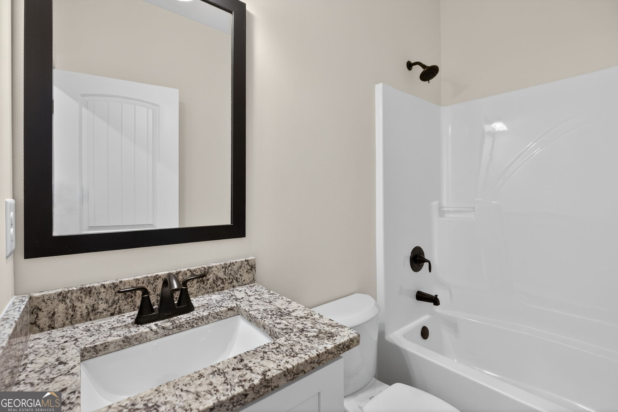 1081 Drummond Road Cedartown, GA 30125 - Photo 50 of 67 a bathroom with a granite countertop sink a toilet and bathtub
