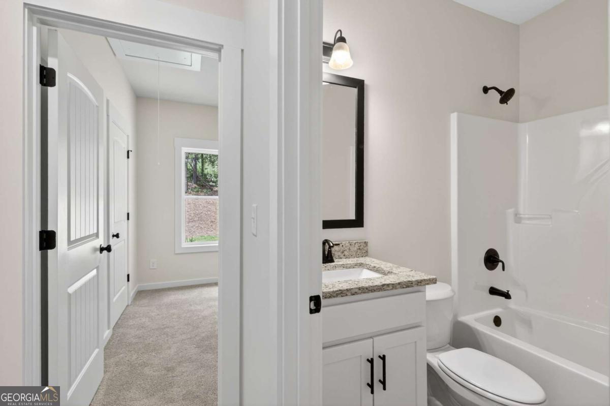 1081 Drummond Road Cedartown, GA 30125 - Photo 51 of 67 a bathroom with a sink a toilet and shower