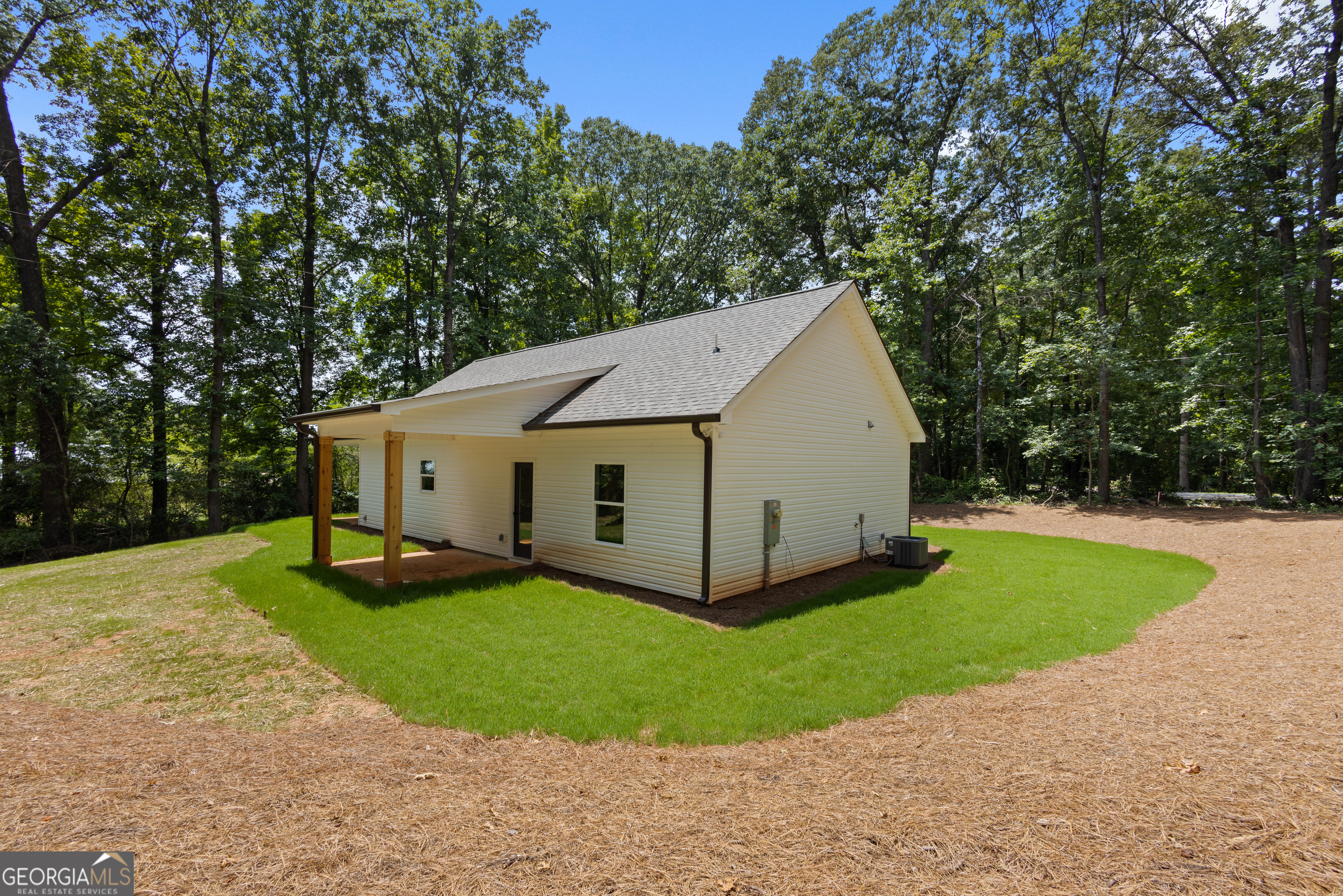 1081 Drummond Road Cedartown, GA 30125 - Photo 56 of 67 a view of a small house with a yard and large trees
