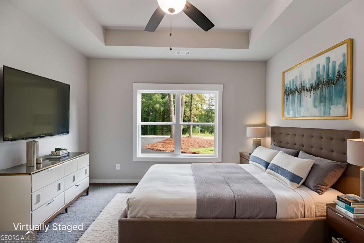 1081 Drummond Road Cedartown, GA 30125 - Photo 7 of 67 a bedroom with a large bed and a flat screen tv