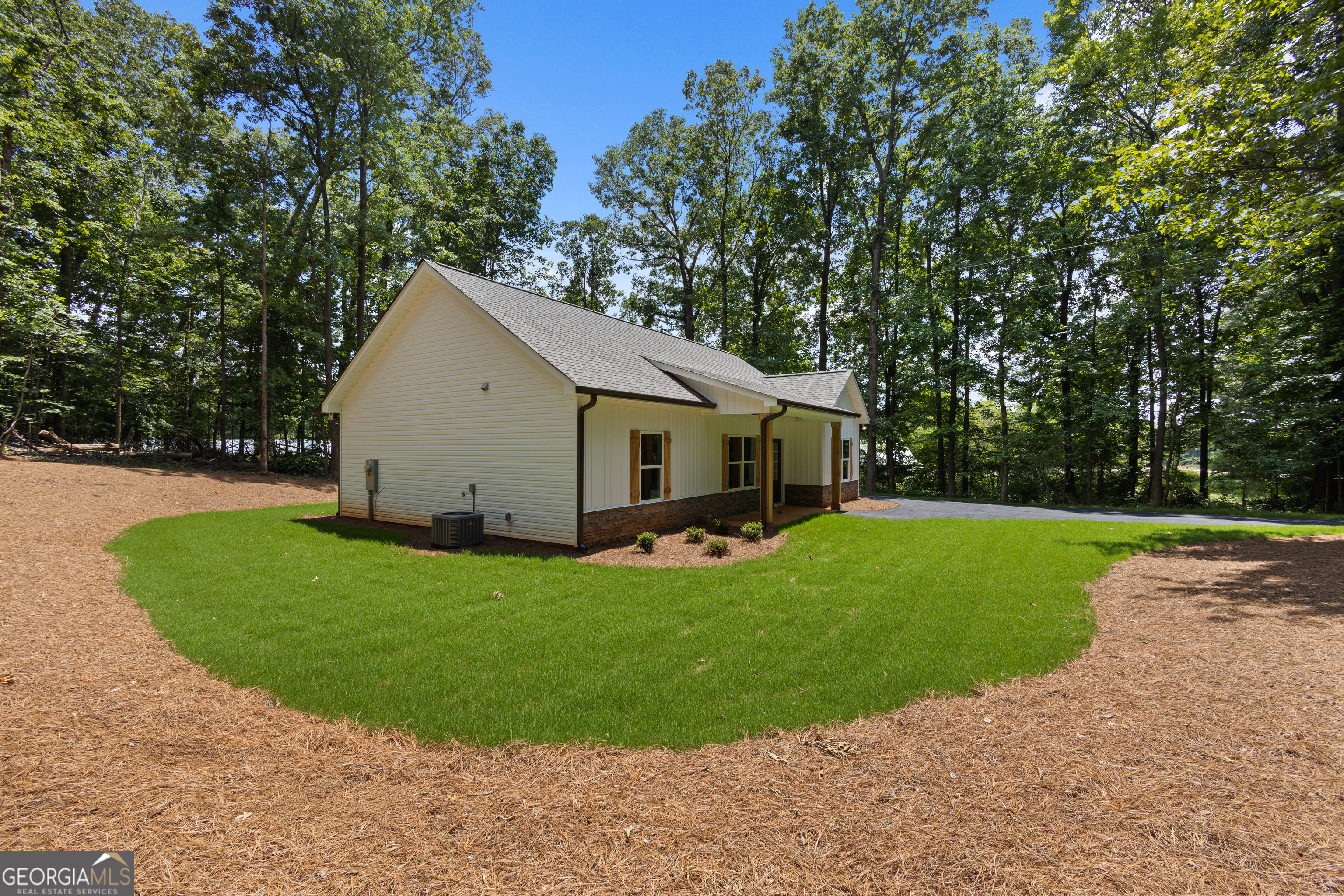 1081 Drummond Road Cedartown, GA 30125 - Photo 8 of 67 a view of a white house in front of a big yard with large trees
