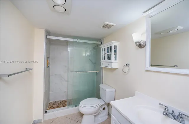 a white toilet sitting next to a bathroom sink