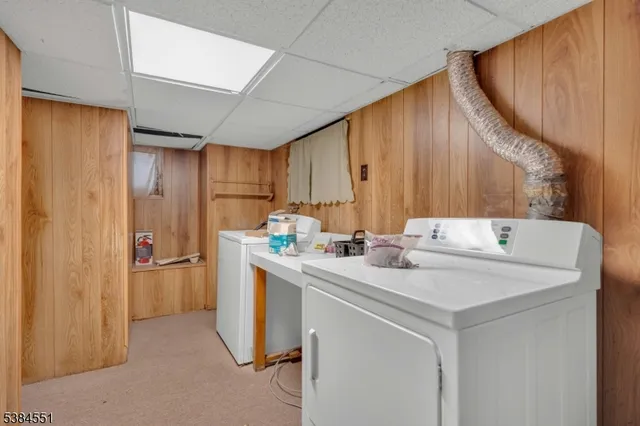 a kitchen with stainless steel appliances a sink a refrigerator and a wooden cabinets