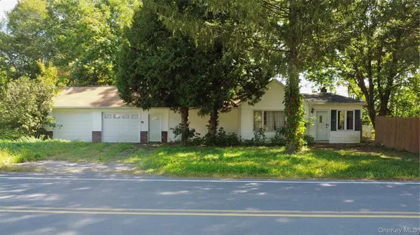 a house that has a tree in front of it