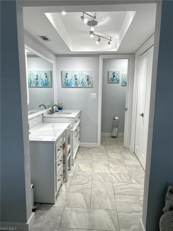 13511 Island Road Fort Myers, FL 33905 - Photo 17 of 38 a spacious bathroom with a sink a mirror and a toilet