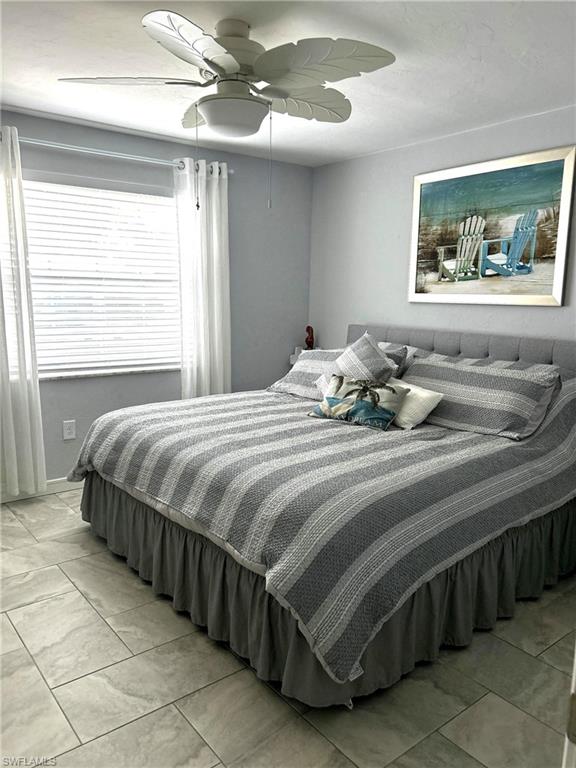 13511 Island Road Fort Myers, FL 33905 - Photo 24 of 38 a bedroom with a bed and a chandelier