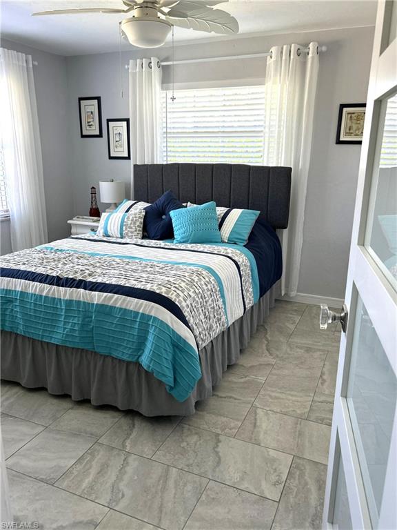 13511 Island Road Fort Myers, FL 33905 - Photo 26 of 38 a bedroom with a bed and a mirror