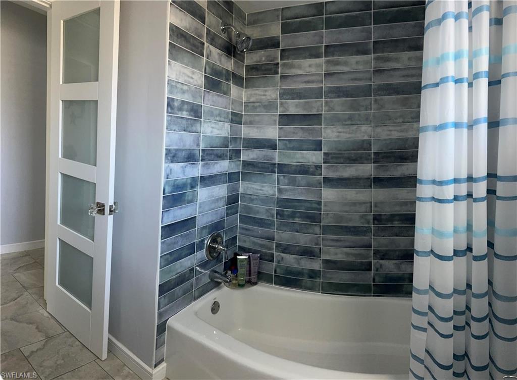 13511 Island Road Fort Myers, FL 33905 - Photo 30 of 38 a bathroom with a bathtub and a shower