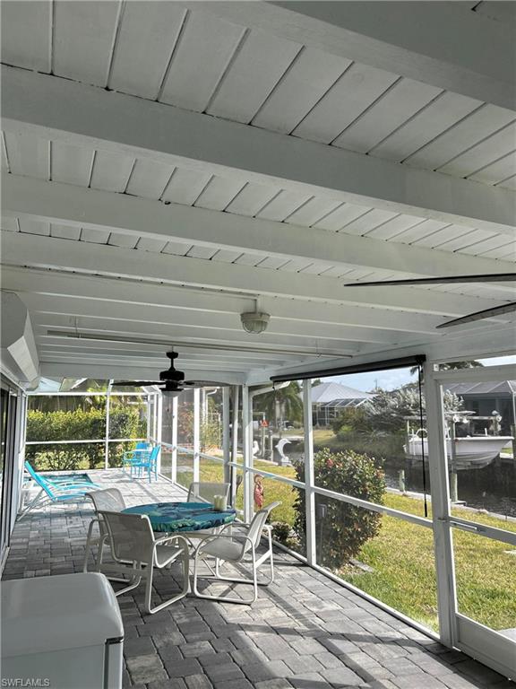 13511 Island Road Fort Myers, FL 33905 - Photo 34 of 38 a view of a patio with table and chairs next to a yard