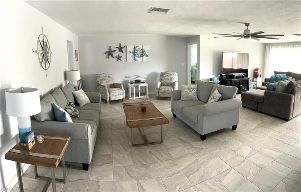 13511 Island Road Fort Myers, FL 33905 - Photo 5 of 38 a living room with furniture and a view of kitchen