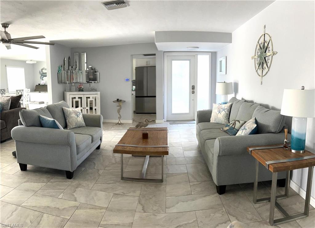 13511 Island Road Fort Myers, FL 33905 - Photo 6 of 38 a living room with furniture and a lamp