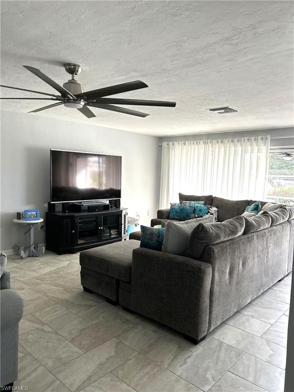 13511 Island Road Fort Myers, FL 33905 - Photo 7 of 38 a living room with furniture and a flat screen tv