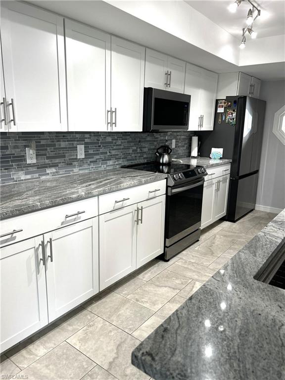 13511 Island Road Fort Myers, FL 33905 - Photo 8 of 38 a kitchen with granite countertop a sink stainless steel appliances and cabinets