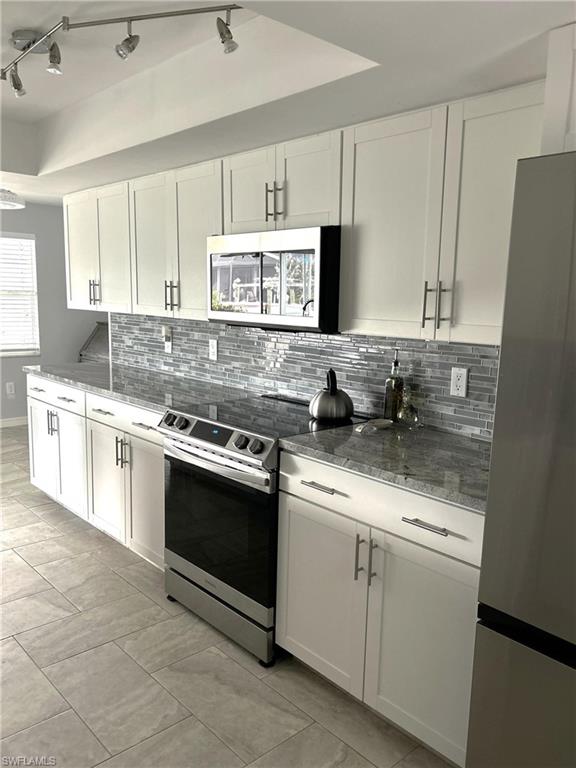 13511 Island Road Fort Myers, FL 33905 - Photo 10 of 38 a kitchen with stainless steel appliances granite countertop a sink stove and refrigerator