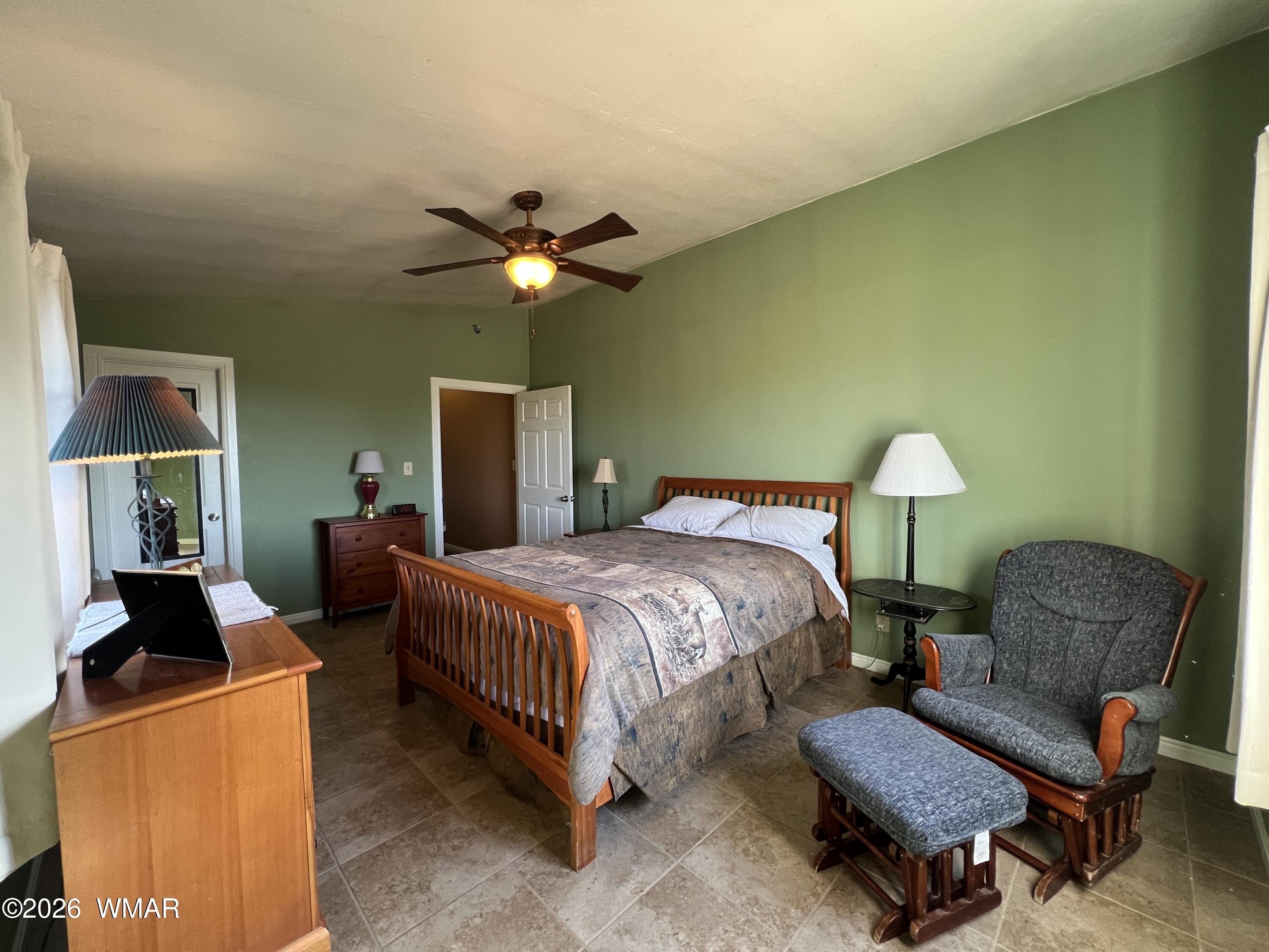 25 North County Road St. Johns, AZ 85936 - Photo 18 of 55 a spacious bedroom with a bed and a chandelier
